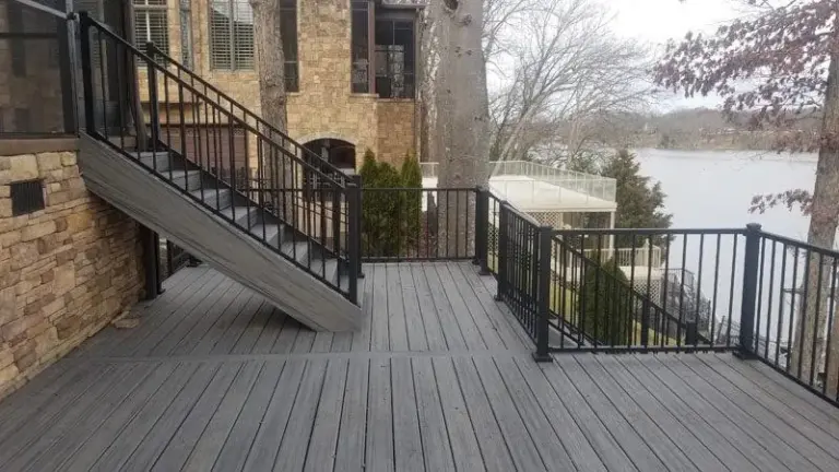Composite deck boards with black aluminum railing and staircase