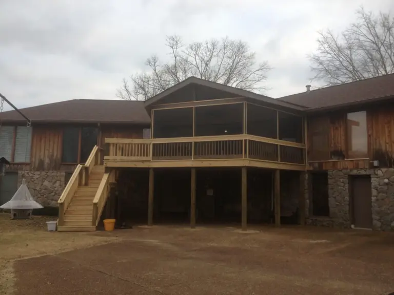 Elevated screened porch with gabled roof and pressure-treated stairs