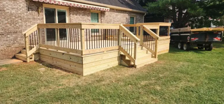 Ground-level deck with solid skirting, railing and steps