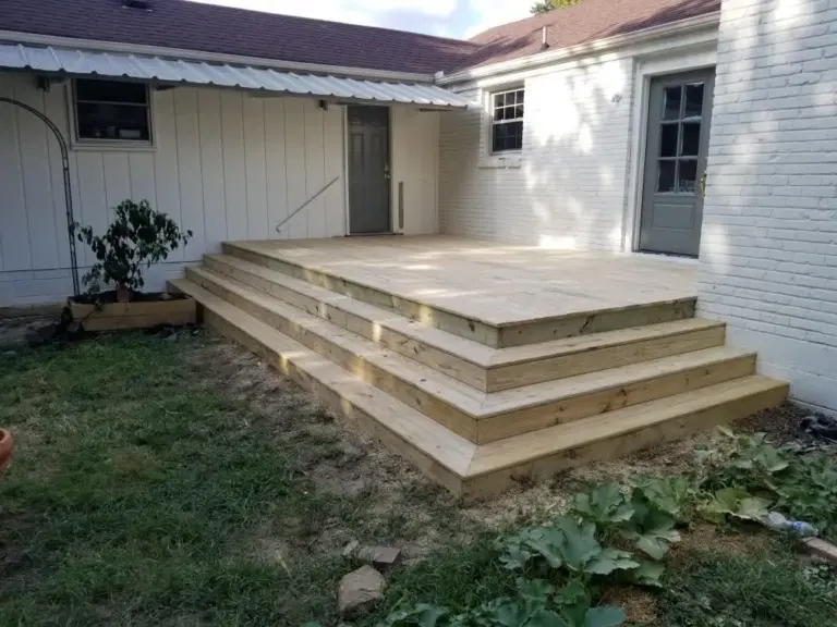 Low-profile platform deck with wide tiered steps at a back door