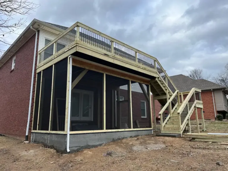Screened porch built beneath an elevated deck with black balusters