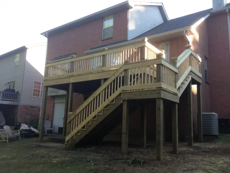 Two-story deck with mid-flight landing and pressure-treated staircase